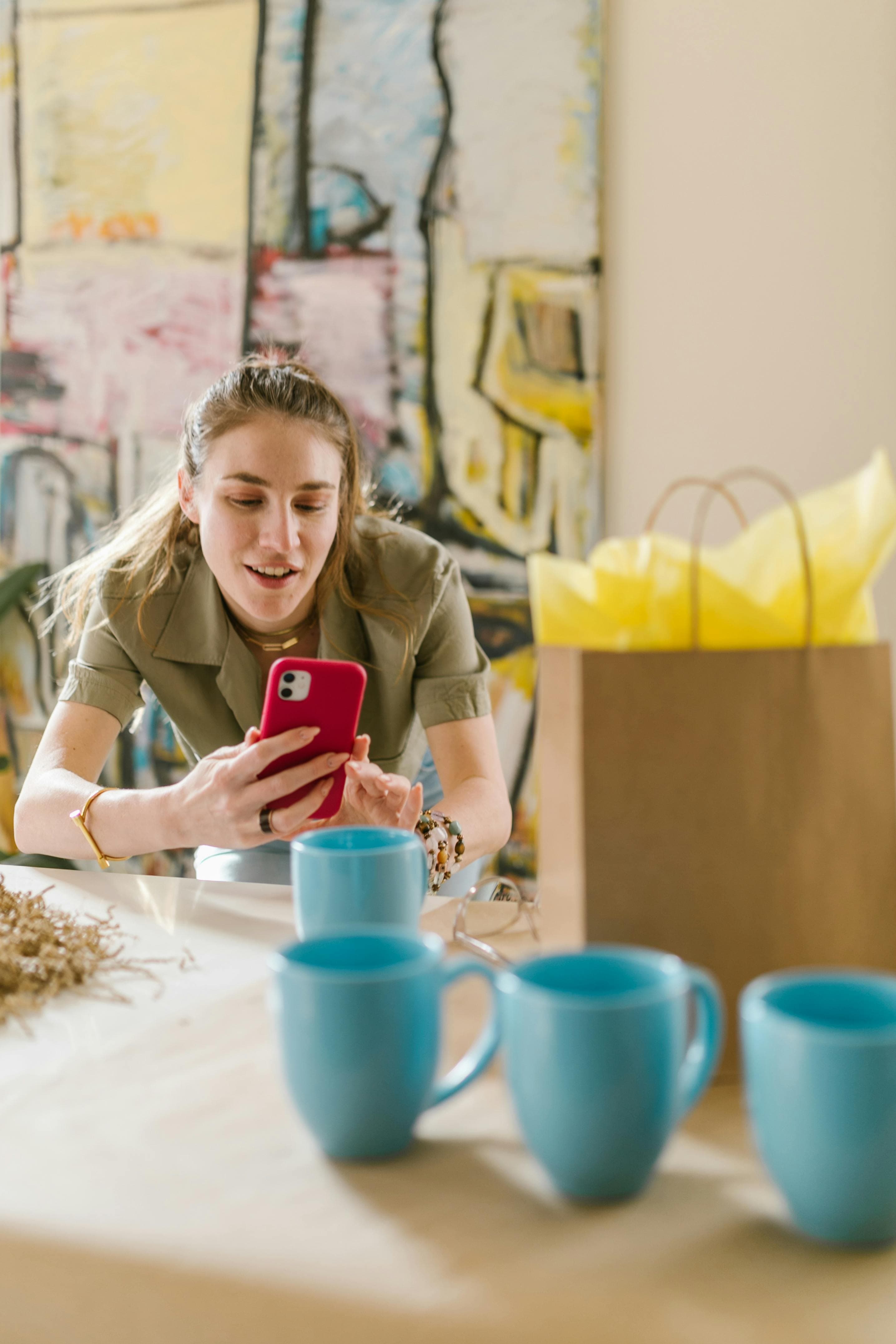 a woman casually holding her smartphone and engaging with content. This image could reflect the role of mobile interface design and its impact on conversion rate optimization, where user behavior and interactions are analyzed to improve conversion metrics on mobile platforms.