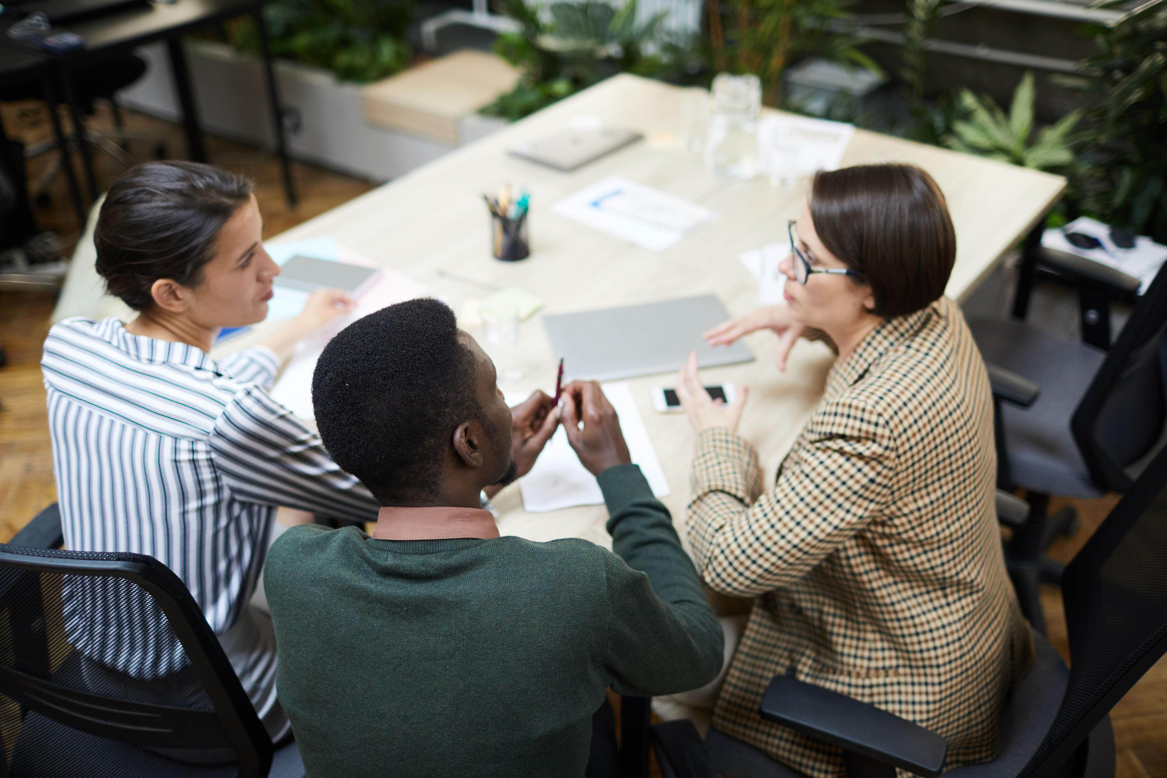 Business team brainstorming strategies for real estate lead generation during a meeting.