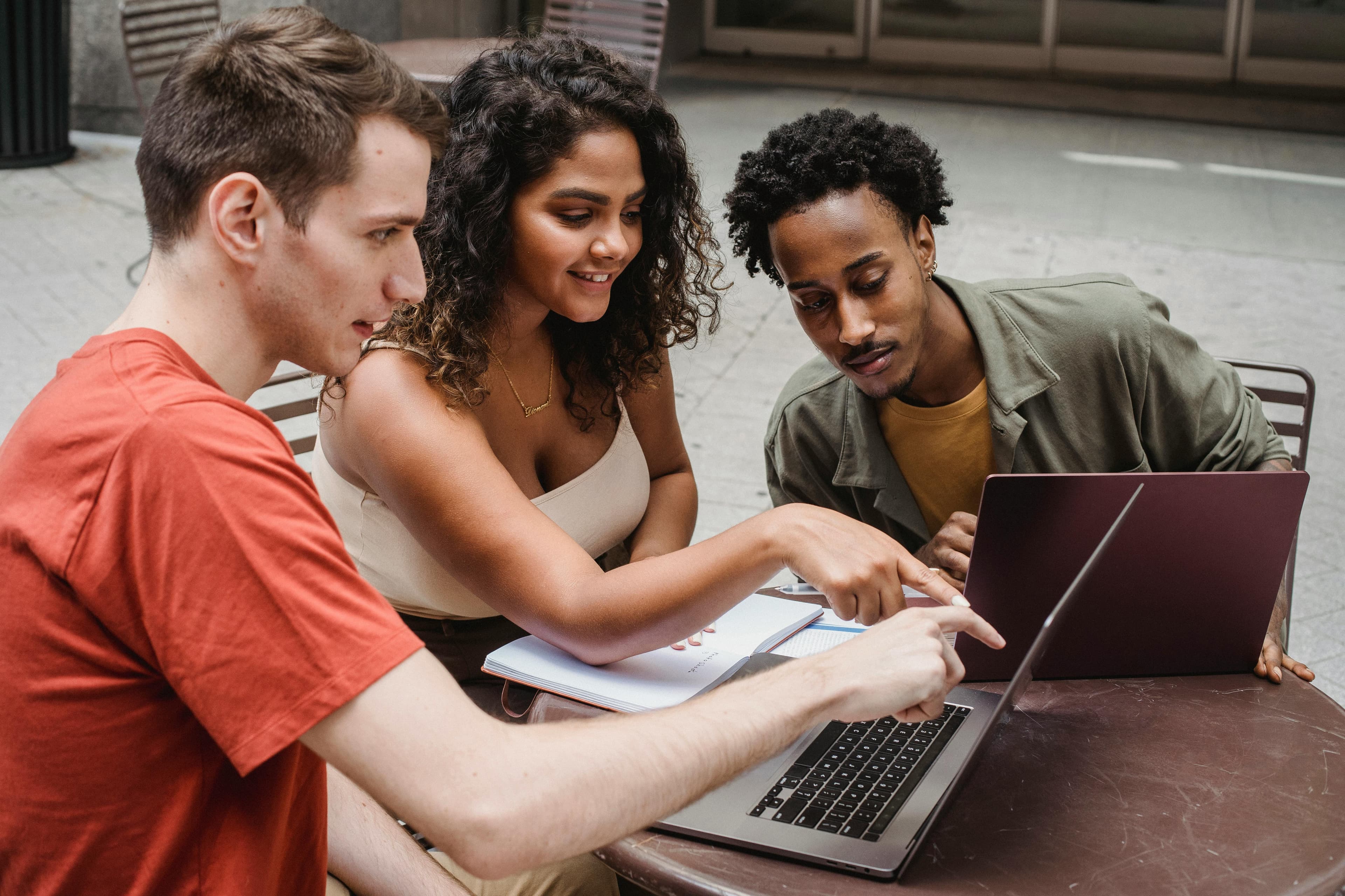 A diverse group of coworkers collaborating on a project, possibly using A/B testing methods to optimize user experience through data analysis.