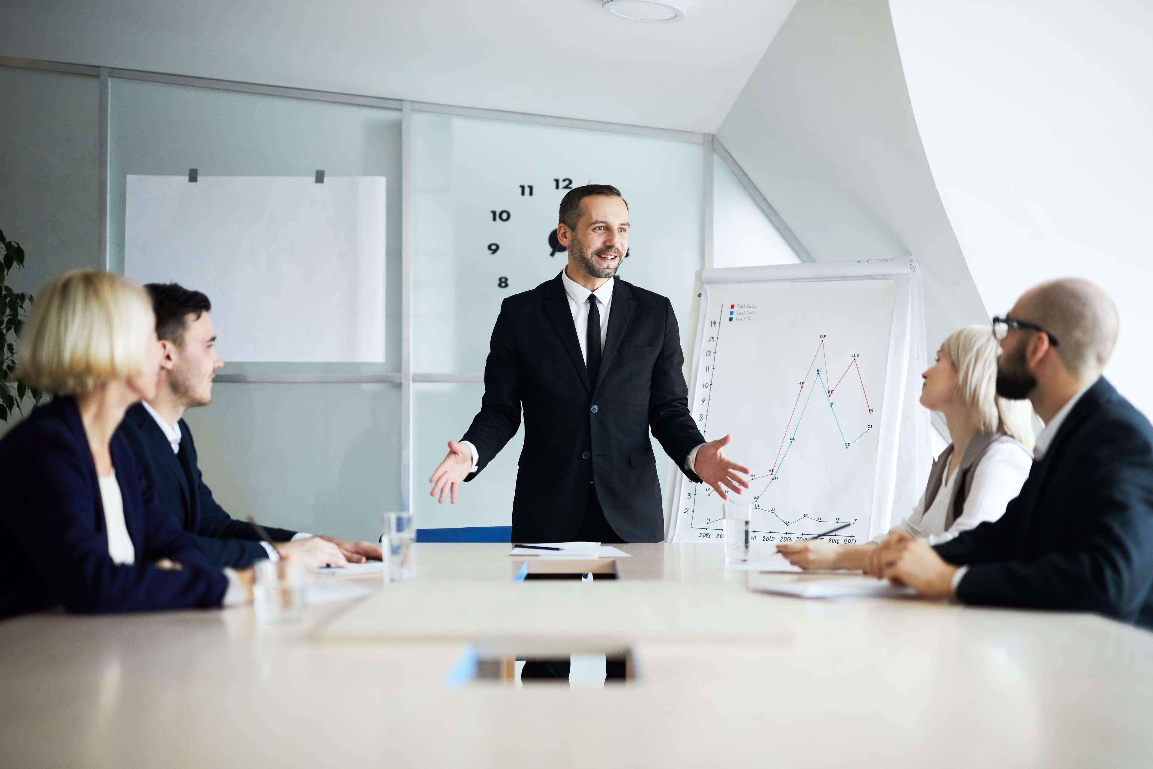 A business leader presenting growth charts during a seminar, highlighting the impact of social media marketing companies in driving successful marketing strategies.